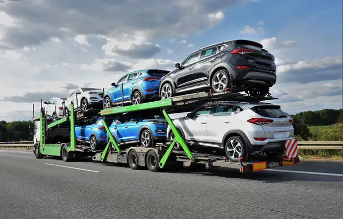 Dealership auto transport — fleet vehicles loaded for dealer-to-dealer shipping